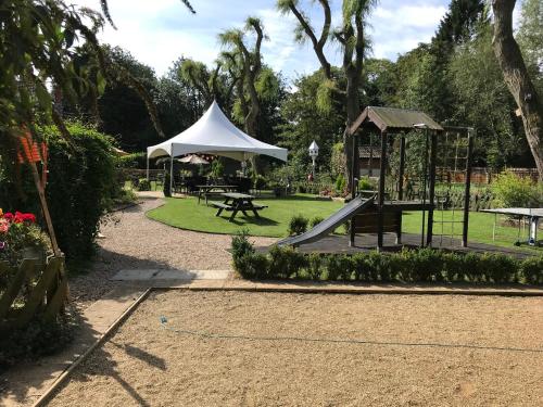 a playground with a slide and a gazebo at The White Lion Inn in Whissendine