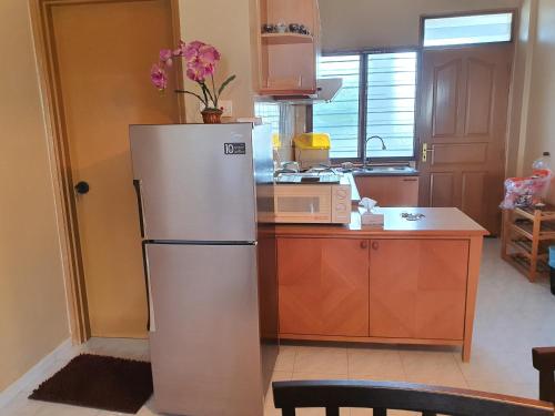 a white refrigerator in a kitchen with a counter at Seri Bulan Condo in Port Dickson