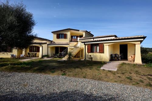 a house with a staircase in front of it at Armandiola in Cardedu