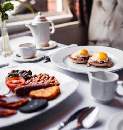 two plates of breakfast foods on a table at Borough Arms Hotel in Stoke on Trent