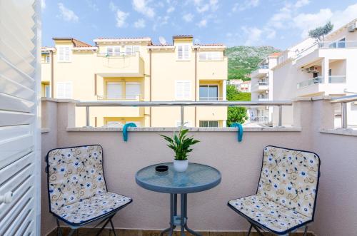 a small table and two chairs on a balcony at Ana Apartment in Cavtat