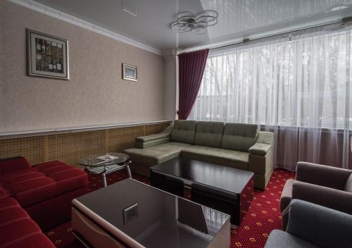a living room with a couch and a table at PARK HOTEL Uralsk in Uralsk