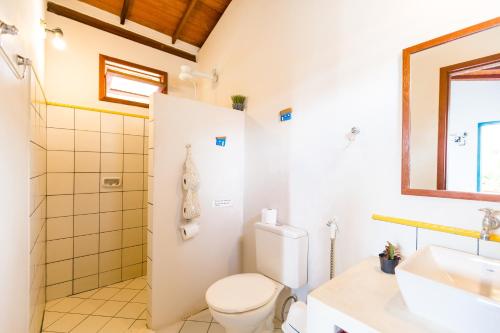 a bathroom with a toilet and a sink at Vila Som do Mar in Trancoso