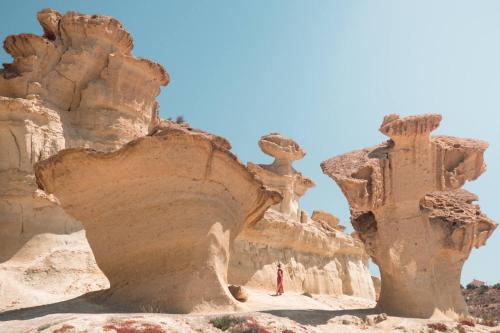 a person stands in front of some rock formations at 2 bed penthouse, Bolnuevo in Bolnuevo