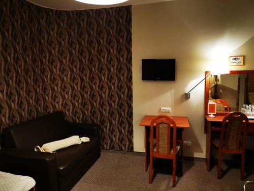 a living room with a couch and a table at Hotel Passione in Bielsko-Biala