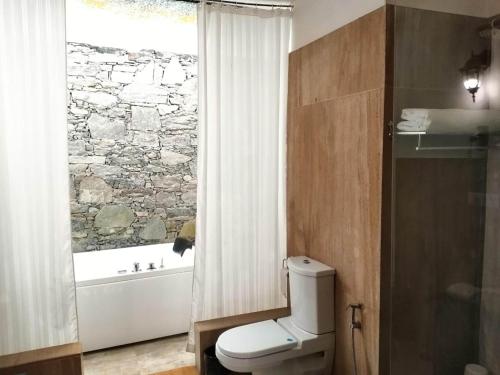 a bathroom with a white toilet and a window at Kumbhalgarh Forest Retreat in Kumbhalgarh