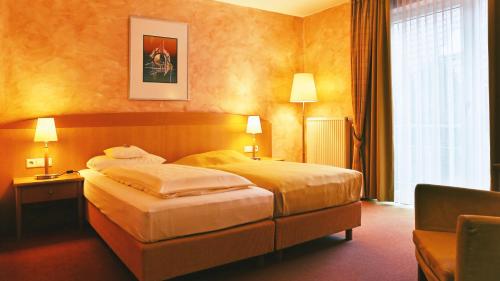 a hotel room with a bed and a window at Businesshotel HEILBRONN- Biberach in Heilbronn