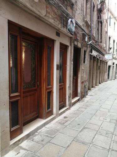 an old building with wooden doors on a street at CASA BANON in Venice