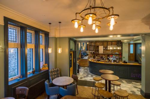 a restaurant with tables and chairs and a bar at The Fleece Hotel Richmond in Richmond