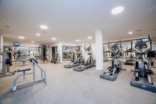 a gym with several treadmills and exercise bikes at Alannia Guardamar in Guardamar del Segura