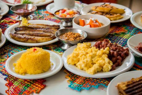 a table full of plates of food on a table at Vistamar Hotel in Maceió