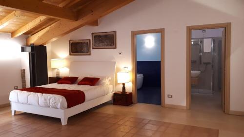 a bedroom with a bed with two red pillows at Agriturismo Casalbergo in Isola della Scala