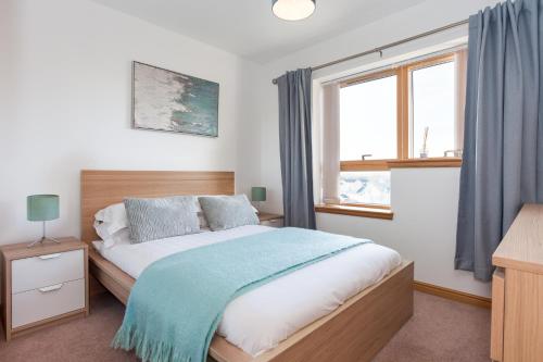 a bedroom with a large bed and a window at Executive 3 Bed Apartment Aberdeen in Aberdeen