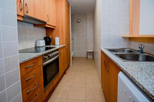 a small kitchen with a sink and a stove at Sol Tarter 4-7 in El Tarter