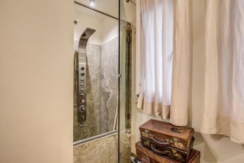 a bathroom with a shower and a wooden stool at Argileto Terra in Rome