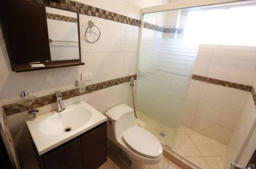 a bathroom with a toilet and a sink and a shower at Posada Villa del Carmen in Catia La Mar