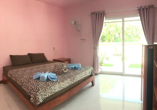 um quarto com uma cama com toalhas azuis em PK Family House em Ko Mook
