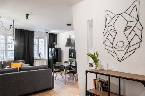 a living room with a couch and a wolf head on the wall at Solny Square Aparthotel in Wrocław