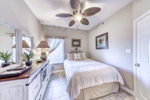 a bedroom with a bed and a ceiling fan at Tidewater II in Orange Beach