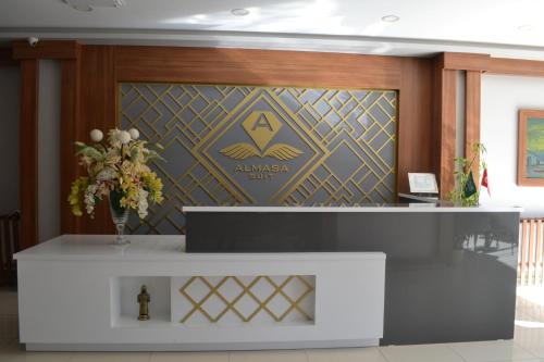 a lobby with a wall with a sign on it at Almasa Suite Aparts in Termal