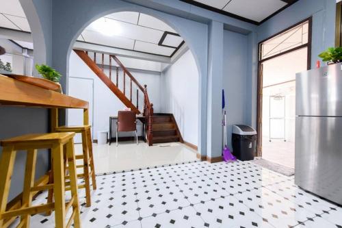 a kitchen with a refrigerator and a tile floor at Bluebell House Hatyai - Cosy 3 bedrooms for 10 pax - 9 mins drive to Lee Grd in Hat Yai