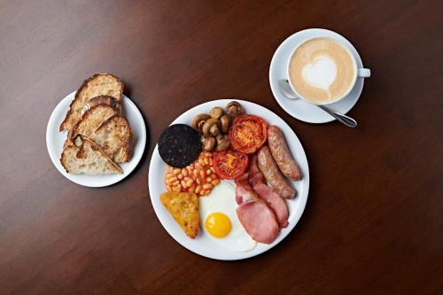 two plates of breakfast food and a cup of coffee at The Merchant's House, BW Signature Collection in Salisbury