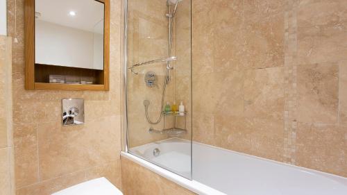 a shower with a glass door in a bathroom at The Abbots Chambers in York