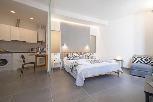 a large bedroom with a bed and a kitchen at Nonno Dante in Riomaggiore