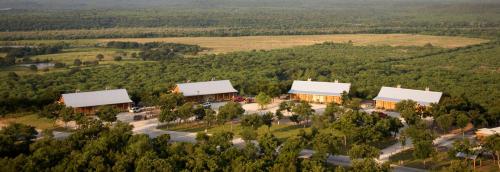 a large house with trees and houses at Wildcatter Ranch and Resort in Graham