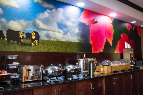 a kitchen with a large mural on the wall at Okatie Hilton Head Hotel in Bluffton
