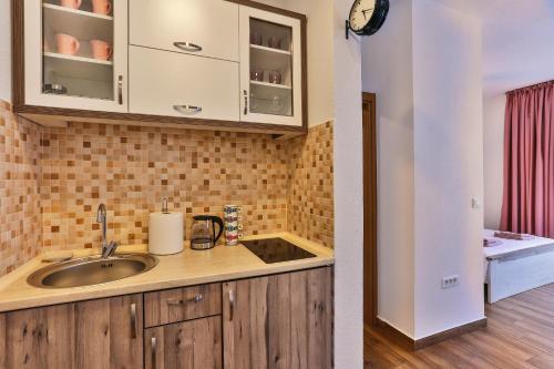 a kitchen with a sink and a counter at Luna Apartmani in Sutomore
