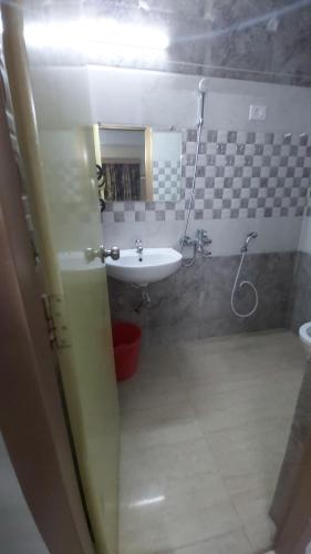a bathroom with a sink and a toilet and a mirror at Hotel Fortune in Patna