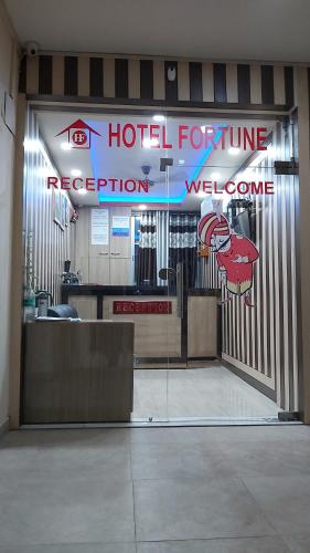 Puerta entreabierta de una habitación de hotel con una futura recepción del hotel en Hotel Fortune, en Patna