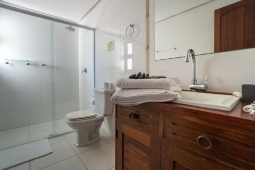 a bathroom with a sink and a toilet and a shower at Pousada Vivenda da Barra in Torres