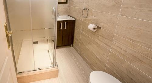 a bathroom with a toilet and a glass shower at Hostal Balmes Centro in Barcelona