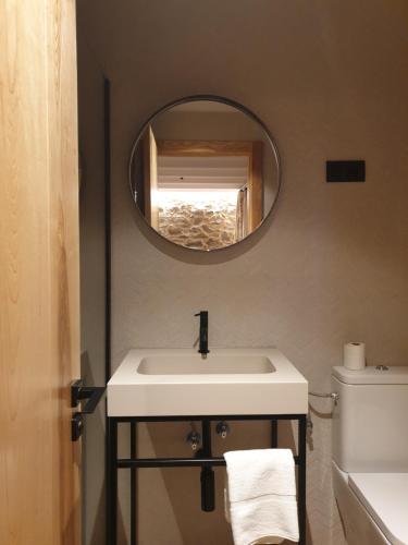a bathroom with a sink and a mirror at La Bordeta de Blas in Gistaín