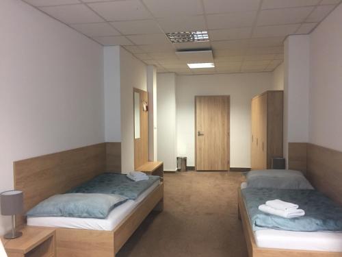 a room with two beds in a room at Hotel Bothe in Považská Bystrica