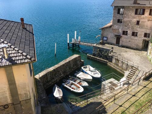three boats are docked in the water next to a building at Chalet Lilia in Brienno