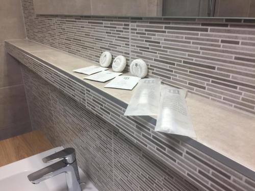 a bathroom with a shelf with two books on it at Hotel Bothe in Považská Bystrica