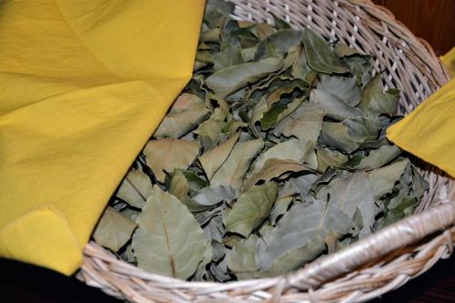 a basket filled with green leaves with a yellow napkin at konaku in Tomin