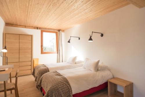 Cama o camas de una habitación en La Ferme du Lignon