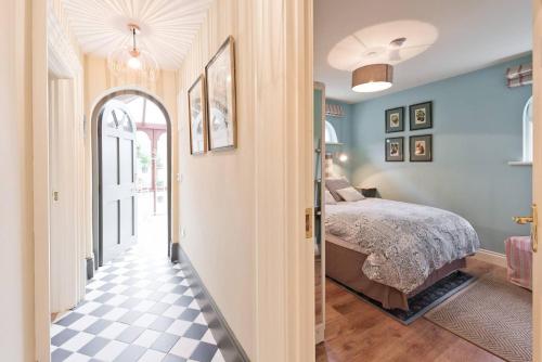 a bedroom with a bed and a checkered floor at The Manor Suite at Moyglare House in Maynooth