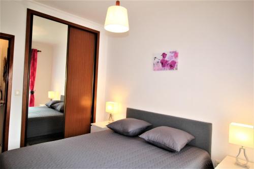 T1+1 Praia da Rocha/ Gaivota Mar 5 في بورتيماو: غرفة نوم بها سرير ومرآة كبيرة