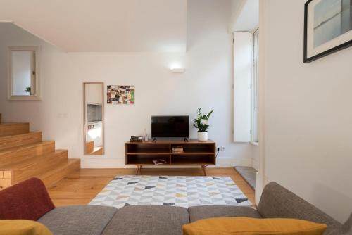 a living room with a couch and a tv at Apartment Firehouse by Sweet Porto - Free Parking in Porto