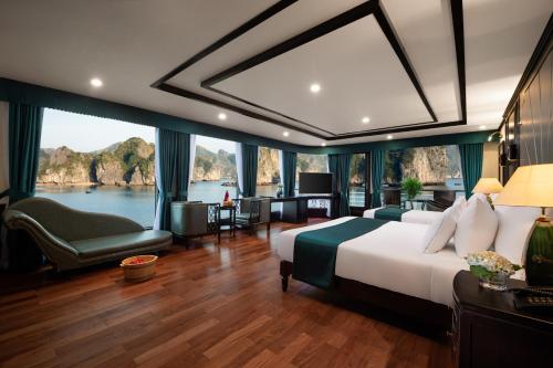a bedroom with a large bed and a large window at Aspira Cruise in Ha Long