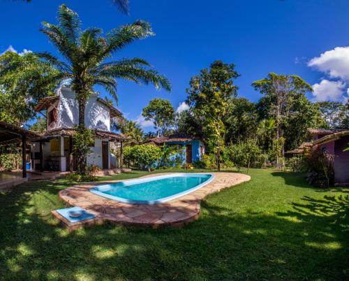an image of a swimming pool in the yard of a house at Espaço Pégasus in Trancoso