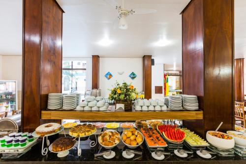 a buffet with many different types of food on display at HsHotelaria - Filial Bombinhas in Bombinhas