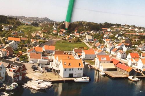 an aerial view of a town with boats in the water at Charming flat in cosy farmhouse in Skudeneshavn