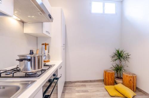 a kitchen with a stove and a sink at Appartamenti Mar y Sol in Gabicce Mare