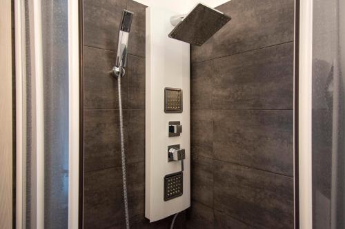 a bathroom with a shower and a shower door at Piccolo Hotel Boutique in Rome